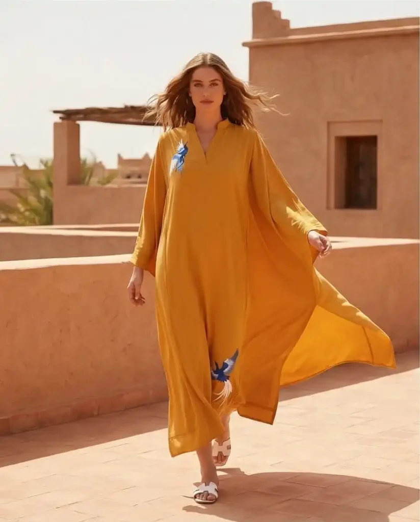 Mustard georgette kaftan with pintucks embroidered birds detailing.